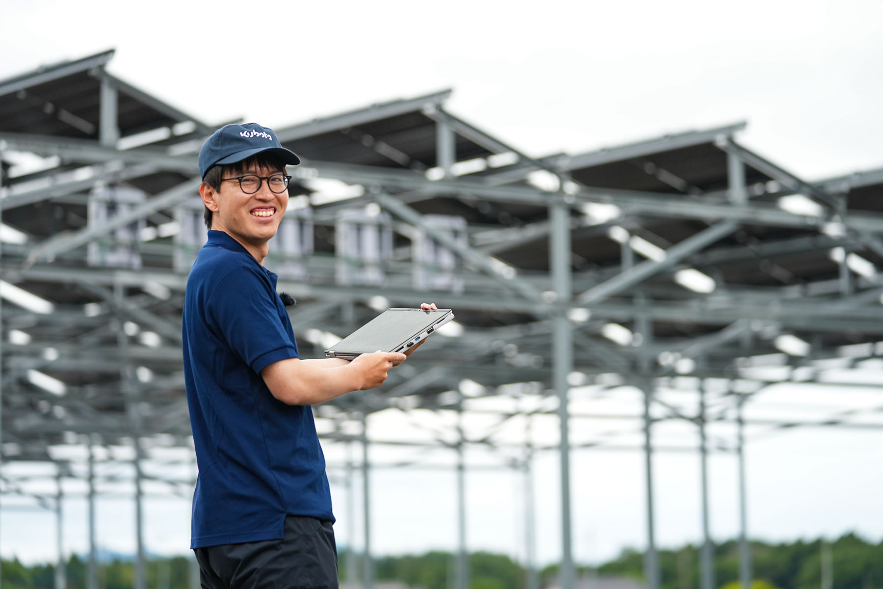 Tani smiling in front of an agrivoltaic installation.